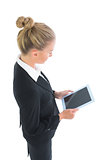 High angle profile view of young businesswoman using her tablet