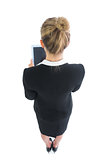 High angle rear view of blonde young woman working with her tablet