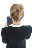 Blonde young businesswoman using her tablet