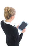 Beautiful blonde businesswoman using her tablet