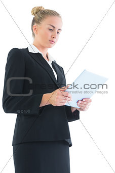 Low angle side view of blonde young woman using her tablet
