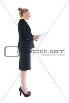 Side view of chic young businesswoman holding her tablet