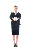 Chic businesswoman holding a piggy bank