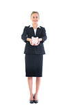 Front view of happy businesswoman holding a piggy bank