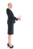 Side view of beautiful blonde businesswoman showing a piggy bank