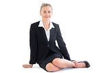 Gorgeous blonde businesswoman sitting on the floor