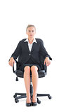 Serious attractive businesswoman sitting on an office chair