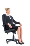 Side view of serious businesswoman sitting on an office chair