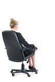 Rear view of chic businesswoman sitting on an office chair