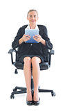 Cheerful pretty businesswoman sitting on an office chair
