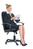 Focused young businesswoman sitting on her office chair