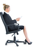 Side view of attractive young businesswoman sitting on an office chair