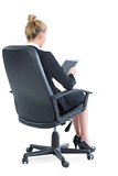 Rear view of lovely businesswoman sitting on an office chair