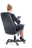 Well dressed young businesswoman sitting on an office chair