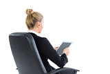 Attractive blonde businesswoman sitting on her office chair