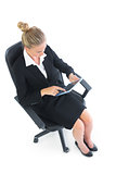 High angle view of pretty businesswoman sitting on an office chair