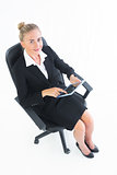Smiling cute businesswoman sitting on her office chair