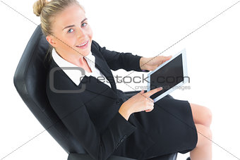 Cheerful young businesswoman sitting on an office chair