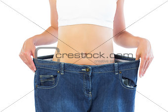 Close up of confident thin blonde wearing too big trousers