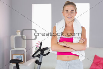 Sporty smiling blonde standing cross armed