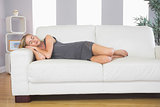 Casual peaceful blonde lying on couch sleeping