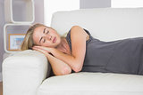 Casual calm blonde lying on couch sleeping