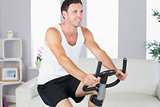 Content sporty man exercising on bike