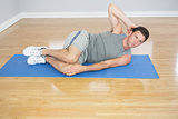 Attractive sporty man doing abdominal crunch