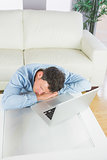 Attractive casual man sleeping with head resting on table
