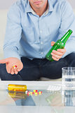 Close up of man showing pills on open hand