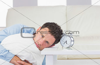Troubled casual man resting head on table