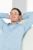 Cheerful casual man relaxing with crossed arms