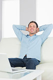 Laughing casual man relaxing with crossed arms