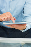 Close up of man holding and using tablet