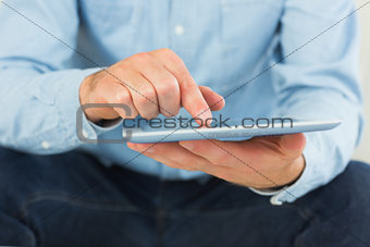 Casual man using and holding tablet