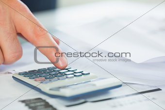 Close up of finger using calculator