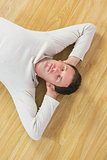 Casual peaceful man lying on floor with closed eyes