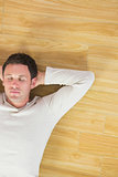 Casual handsome man lying on floor with closed eyes