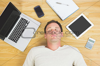 Casual tired man lying on floor