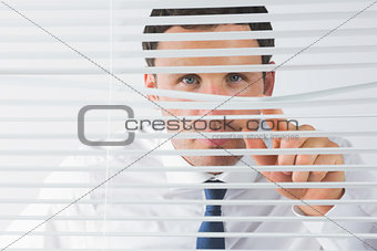 Handsome businessman spying