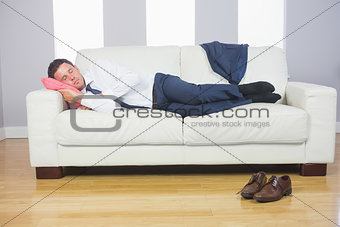 Calm attractive businessman lying on couch
