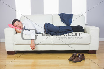Calm handsome businessman sleeping on couch