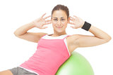 Content sporty brunette doing sit ups on exercise ball