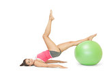 Smiling sporty brunette exercising with exercise ball