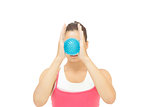 Toned brunette holding blue massage ball between hands