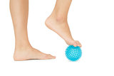 Close up of female feet touching blue massage ball