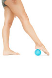 Close up of female legs touching blue massage ball
