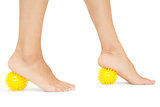 Close up of female feet touching yellow massage balls