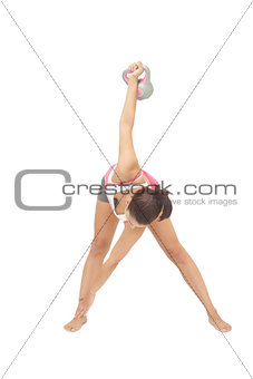 Sporty brunette exercising with kettlebell