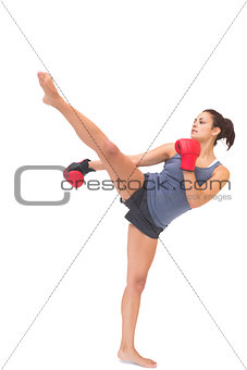 Attractive sporty brunette kick boxing